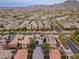 A wide aerial view of a neighborhood with mountain views in the distance and many homes with solar panels at 2305 N Heritage St, Buckeye, AZ 85396