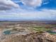 Sweeping aerial view featuring a community nestled in a desert landscape, complete with a golf course and distant mountain views at 2305 N Heritage St, Buckeye, AZ 85396