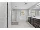 Bathroom features a glass shower, tub, and dark cabinets, providing a luxurious bathing experience at 2305 N Heritage St, Buckeye, AZ 85396