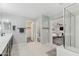 Bathroom offers a glass shower, tub, dark cabinets, and access to the Primary bedroom and closet at 2305 N Heritage St, Buckeye, AZ 85396