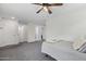 Bright bedroom featuring neutral tones, plush carpeting, and a ceiling fan at 2305 N Heritage St, Buckeye, AZ 85396