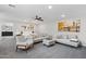 Bedroom features an adjoining living area with sofas, an ottoman, and artwork at 2305 N Heritage St, Buckeye, AZ 85396