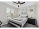 Well-lit bedroom with shutters, light gray walls, and a comfortable bed at 2305 N Heritage St, Buckeye, AZ 85396