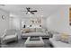 Comfortable bedroom with a sitting area, ceiling fan, and a view of the en-suite bathroom at 2305 N Heritage St, Buckeye, AZ 85396