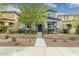 Inviting two-story home with stone-accented porch columns and a landscaped front yard in a suburban setting at 2305 N Heritage St, Buckeye, AZ 85396
