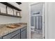 Hallway area with granite countertops and a chess board on top of the cabinets at 2305 N Heritage St, Buckeye, AZ 85396