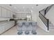 Spacious kitchen with a central island, bar stools, and modern gray cabinets at 2305 N Heritage St, Buckeye, AZ 85396