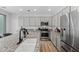Well-equipped kitchen with granite counters, stainless steel appliances, and modern gray cabinetry at 2305 N Heritage St, Buckeye, AZ 85396