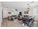Open-concept living and dining area with wood floors, modern lighting, and comfortable seating ideal for entertaining at 2305 N Heritage St, Buckeye, AZ 85396