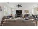 Bright living room featuring stylish sofas, a large TV, and contemporary decor creating a welcoming atmosphere at 2305 N Heritage St, Buckeye, AZ 85396