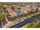 Picturesque street view with colorful homes, manicured landscaping, and parked cars under shaded trees at 2305 N Heritage St, Buckeye, AZ 85396