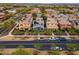 Lovely aerial shot of a suburban street, lined with colorful homes and cars parked on the street at 2305 N Heritage St, Buckeye, AZ 85396
