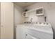 Laundry room with a washer and dryer set, storage cabinets, and utility hookups at 2315 W Union Hills Dr # 120, Phoenix, AZ 85027