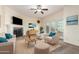 Bright living room featuring a fireplace, ceiling fan, and access to a small outdoor patio at 2315 W Union Hills Dr # 120, Phoenix, AZ 85027