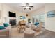Comfortable living room featuring a fireplace, ceiling fan, and access to the outdoors through glass doors at 2315 W Union Hills Dr # 120, Phoenix, AZ 85027