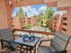 Scenic balcony view overlooking the community pool and lush landscaping, with seating and refreshments provided at 4303 E Cactus Rd # 407, Phoenix, AZ 85032