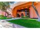 Inviting building entrance with landscaped greenery, a well-maintained lawn, and distinctive architectural details at 4303 E Cactus Rd # 407, Phoenix, AZ 85032