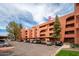 Exterior view of an apartment complex with covered parking, surrounded by trees and landscaping at 4303 E Cactus Rd # 407, Phoenix, AZ 85032