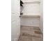 Walk-in closet with ample storage, showcasing shelving and wood-look flooring at 4303 E Cactus Rd # 407, Phoenix, AZ 85032