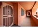 Hallway featuring a decorative metal security gate and a view down the hall at 4303 E Cactus Rd # 407, Phoenix, AZ 85032