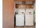 Convenient laundry room equipped with a washer and dryer and cabinet storage at 4303 E Cactus Rd # 407, Phoenix, AZ 85032