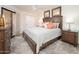 Cozy main bedroom featuring a large bed, soft lighting, and a sliding glass door at 4303 E Cactus Rd # 407, Phoenix, AZ 85032