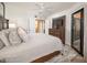 Comfortable main bedroom with a ceiling fan, dresser with TV, and an ensuite bathroom at 4303 E Cactus Rd # 407, Phoenix, AZ 85032