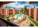 Exterior shot from above of the community pool with buildings, rocks, plants, and trees surrounding it at 4303 E Cactus Rd # 407, Phoenix, AZ 85032