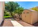 A lush backyard with a picnic table and storage shed create a private retreat at 5752 S Crossbow Pl, Chandler, AZ 85249