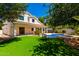 A lush backyard, featuring an artificial grass lawn, a pool, and a patio at 5752 S Crossbow Pl, Chandler, AZ 85249