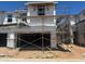 Exterior shot of new construction home at framing stage with scaffolding and garage at 5824 E Covey Ln, Phoenix, AZ 85054