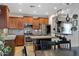 Spacious kitchen featuring wood cabinets, stainless steel appliances, island and dining set at 88 W Reeves Ave, San Tan Valley, AZ 85140