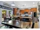 Eat-in kitchen with stainless appliances, wood cabinetry, and access to outdoor patio at 88 W Reeves Ave, San Tan Valley, AZ 85140