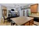 Open kitchen featuring a dark wood island and dining area with french doors to the patio at 88 W Reeves Ave, San Tan Valley, AZ 85140