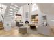 Bright living room with fireplace, high ceilings, hardwood floors, and staircase at 8845 S 48Th St # 1, Phoenix, AZ 85044