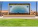Community stage with a desert mural on a lush lawn, perfect for outdoor events at 927 S Roanoke --, Mesa, AZ 85206