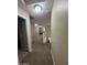 Second-floor hallway overlooking stairs with carpeted floors at 23236 W Yavapai St, Buckeye, AZ 85326