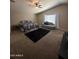 Relaxing main bedroom with a plush bed, chaise lounge, and neutral decor, offering comfort and style at 23236 W Yavapai St, Buckeye, AZ 85326