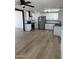 Modern kitchen with white cabinets, stainless steel appliances, and beautiful wood-look flooring at 3040 N 39Th Ave, Phoenix, AZ 85019