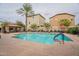 Inviting community pool surrounded by lounge chairs and lush landscaping for relaxation and leisure at 4287 E Tyson St, Gilbert, AZ 85295