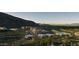 Expansive aerial view of luxury homes, a golf course, lush landscaping, and majestic mountains at 4849 N Camelback Ridge Rd # A309, Scottsdale, AZ 85251