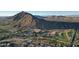 Stunning aerial view of a golf course community, a luxury hotel, and mountain views in the background at 4849 N Camelback Ridge Rd # A309, Scottsdale, AZ 85251
