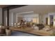 Open-concept living space featuring modern kitchen, dining area, comfortable seating, and seamless access to an outdoor space at 4849 N Camelback Ridge Rd # A309, Scottsdale, AZ 85251
