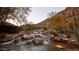 Picturesque water feature cascading down rocks surrounded by lush desert landscape at 4849 N Camelback Ridge Rd # A309, Scottsdale, AZ 85251