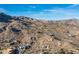 Aerial view of a luxury community with homes nestled in the desert landscape with mountain views at 11130 E Rolling Rock Dr, Scottsdale, AZ 85262