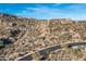 Desert homes atop rocky landscape with lush greenery, offering stunning views and luxurious living in a serene community at 11130 E Rolling Rock Dr, Scottsdale, AZ 85262
