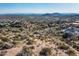Expansive desert landscape with city views, native vegetation, and a winding road through the neighborhood at 11130 E Rolling Rock Dr, Scottsdale, AZ 85262