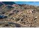 Scenic desert view with native vegetation, a winding road, and surrounding homes blended into the landscape at 11130 E Rolling Rock Dr, Scottsdale, AZ 85262