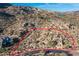Highlighted view of desert land with native vegetation, a winding road, and homes in the distance at 11130 E Rolling Rock Dr, Scottsdale, AZ 85262