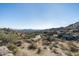 Expansive desert view showcasing luxury home nestled in mountainside community at 11130 E Rolling Rock Dr, Scottsdale, AZ 85262